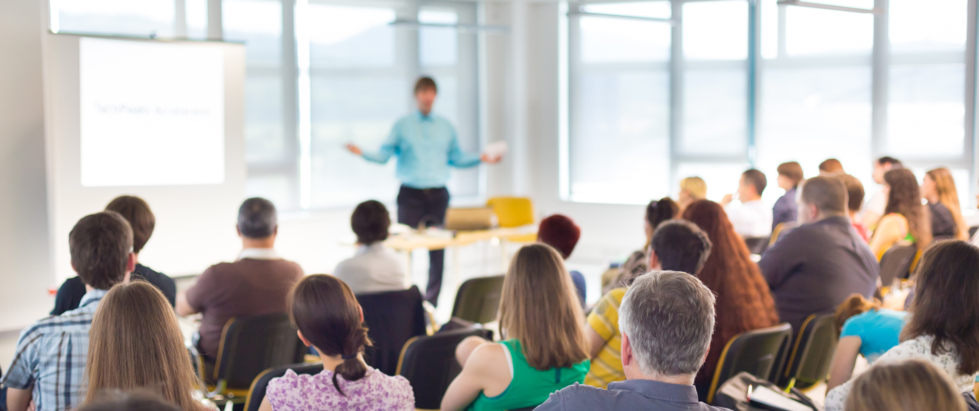 Group of people seated for meeting with a person leads